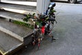 Bicycle hung with various objects locked by a railing. someone stole the front wheel. colorful mountain old bike Royalty Free Stock Photo