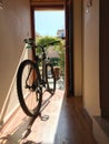 Bicycle indoor home at open door entrance Royalty Free Stock Photo