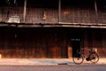 The bicycle infornt of the ancient wooden house Royalty Free Stock Photo