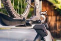 Bicycle installed to roof bike rack on a silver car