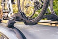 Bicycle installed to roof bike rack on a silver car