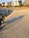 Bicycle and its shadow on the beach. Black bicycle with a lock chain waiting on a sunny summer day