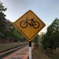 Bicycle lane sign board against sunset