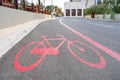 Bicycle lane with special sign made with red paint on the pavement, city view, outdoors, copy space
