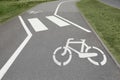 Bicycle lane with white sign painted on asphalt near sidewalk Royalty Free Stock Photo