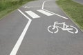 Bicycle lane with white sign painted on asphalt near sidewalk Royalty Free Stock Photo