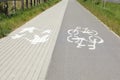 Bicycle lane with white sign painted on asphalt near sidewalk Royalty Free Stock Photo