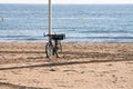 Bicycle resting on a lamppost in the sand of the beach Royalty Free Stock Photo