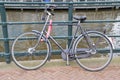 Bicycle Locked At A Gate At Amsterdam The Netherlands