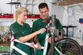 Bicycle mechanic and apprentice repairing a bike Royalty Free Stock Photo