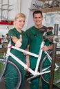 Bicycle mechanic and apprentice repairing a bike Royalty Free Stock Photo