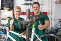Bicycle mechanic and apprentice repairing a bike Royalty Free Stock Photo