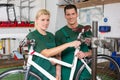 Bicycle mechanic and apprentice repairing a bike Royalty Free Stock Photo