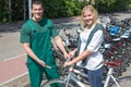 Bicycle mechanic in bike shop consulting a customer