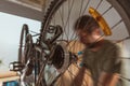 Bicycle mechanic repairing old mountain bike in workshop Royalty Free Stock Photo