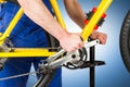 Bicycle mechanic tightening pedal Royalty Free Stock Photo