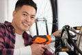 bicycle mechanic uses cordless powertool Royalty Free Stock Photo