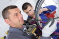 Bicycle mechanic working in bike workshop Royalty Free Stock Photo