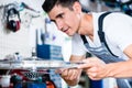 Bicycle mechanic working in his bike workshop