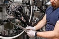 Bicycle mechanic in a workshop in the repair process Royalty Free Stock Photo