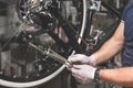 Bicycle mechanic in a workshop in the repair process Royalty Free Stock Photo