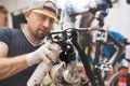 Bicycle mechanic in a workshop in the repair process Royalty Free Stock Photo