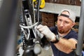 Bicycle mechanic in a workshop in the repair process Royalty Free Stock Photo