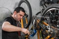Bicycle mechanic in a workshop in the repair process. Royalty Free Stock Photo