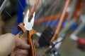 Bicycle mechanic in a workshop in the repair process, holds a tool in his hand Royalty Free Stock Photo