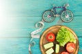 bicycle model, fresh vegetables and centimeter tape on blue wood Royalty Free Stock Photo