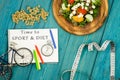 bicycle model, salad of fresh vegetables, notepad with text & x22;Time to SPORT & DIET& x22;, stopwatch and tape measure Royalty Free Stock Photo