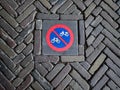 Bicycle and moped sign on stone sidewalk in Amsterdam