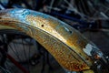 Bicycle mudguard with rust and remnants of stickers, detail, abs