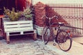 Bicycle near outdoors cafe on old street.