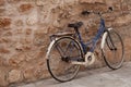 Bicycle near stone wall.