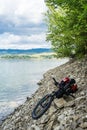 Bicycle with panniers on the rocky beach of Czorsztyn Lake