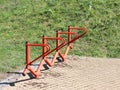 Bicycle park. Metal orange handrails for parking bicycles. A device to make life easier for cyclists. Facilities for the city`s ec
