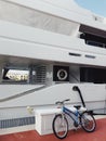 Bicycle parked against big yacht in cap Cana marina