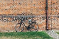 Bicycle parked against old brick wall of church in Wismar, Germany