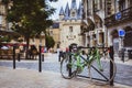 Bicycle parked against railing in Bordeaux with Port Cailhau in
