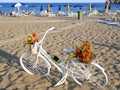 Bicycle Parked On A Beach Next To The Umbrellas
