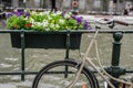 Bicycle parked on the bridge with flowers in Amsterdam Holland Royalty Free Stock Photo