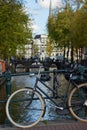 A bicycle parked on a bridge over an Amsterdam canal Royalty Free Stock Photo