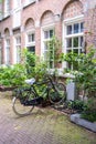 Bicycle parked in front of a red brick building, Amsterdam city neighborhood. Holland Netherlands Royalty Free Stock Photo