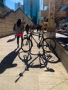 Bicycle parked on Lake Street casts shadows along with pedestrian/commuter shadows