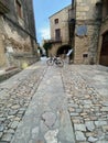 Bicycle parked in the middle of a cobble stone street in an old medieval beautiful town in Peratallada, Costa Brava, Catalonia Royalty Free Stock Photo