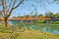 Bicycle parked near a river and the orange bridge