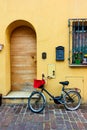 Bicycle parked next to door of old house