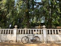 A bicycle parked outside the wall of an ancient Portuguese era wall in Old Goa