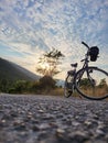 Bicycle parked on the road against a sunset in Prapratno, Croatia